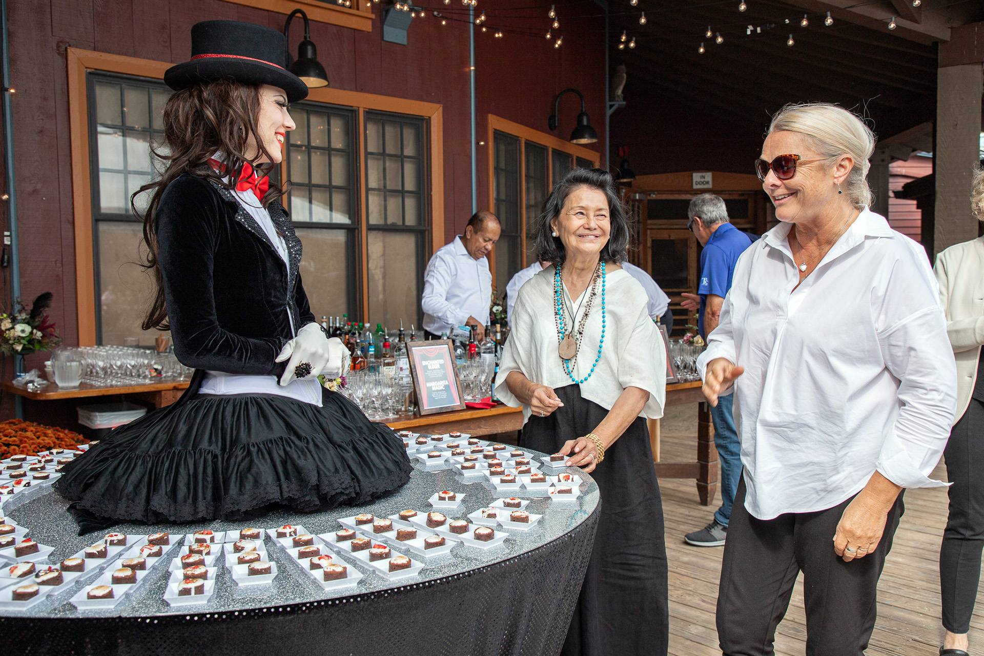 2024 Gala attendees stop for a chat and dessert bite at the walking dessert station