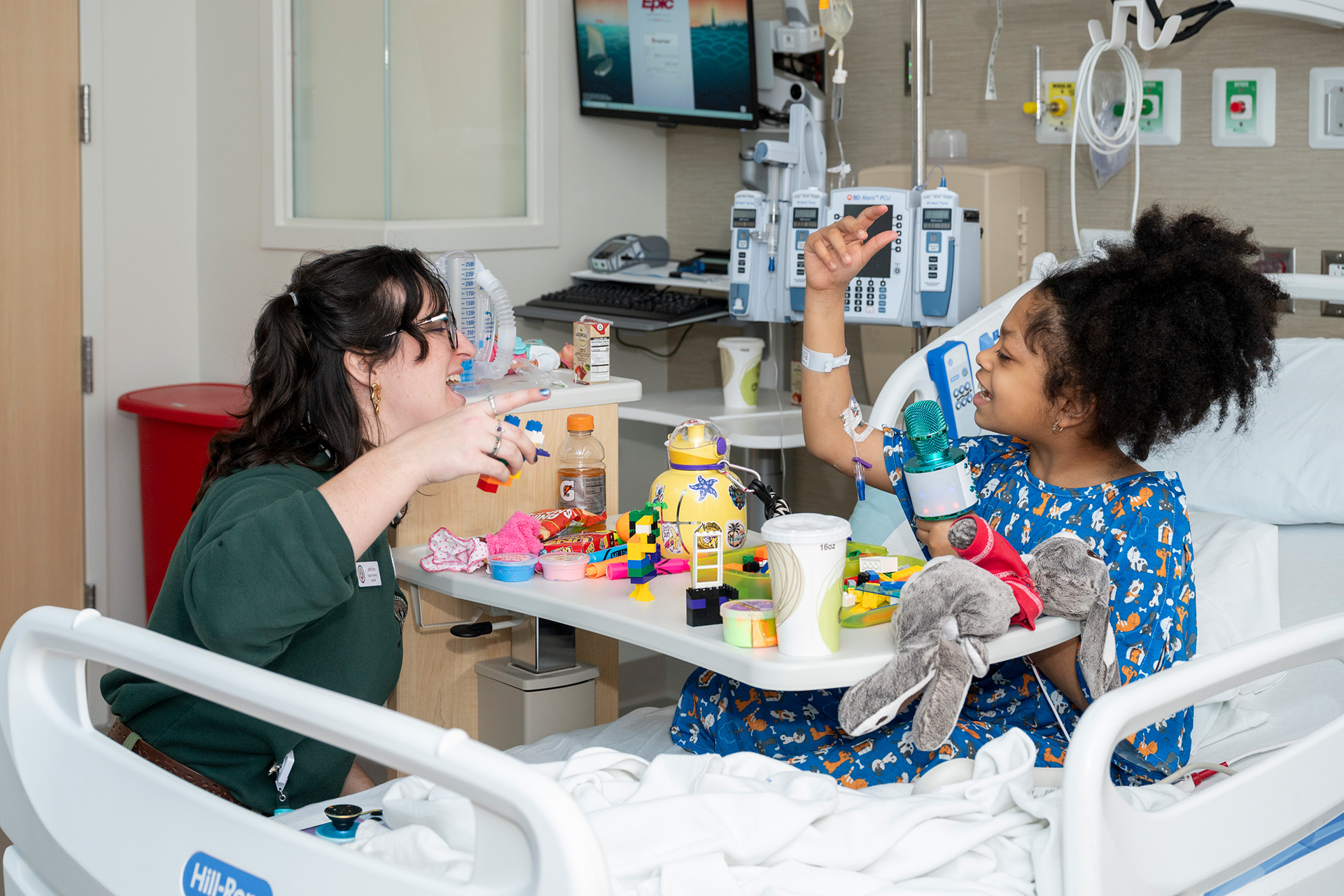 HOP specialist vists with friend in their hospital bed