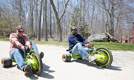 Parents riding Big Wheels