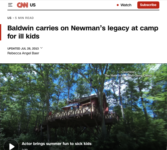 A treehouse-style cabin sits among green trees at a summer camp. The headline reads, Baldwin carries on Newmans legacy at camp for ill kids. A caption mentions an actor bringing summer fun to sick kids.
