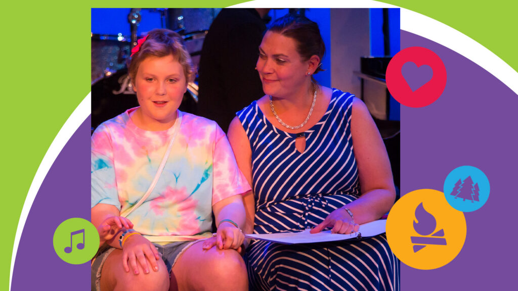 A girl in a tie-dye shirt sits next to a woman in a striped dress, who is holding papers. Both are smiling. Colorful icons—music note, heart, trees, and campfire—decorate the border.
