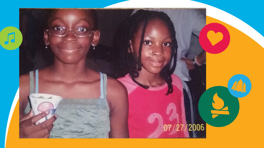 Two young girls smile at the camera; one wears glasses and holds a cup, the other wears a pink shirt. Colorful icons and shapes decorate the photos border. Date stamp reads 07/27/2006.