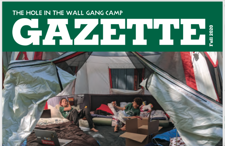 Two people relax inside a large tent filled with bedding and boxes. The tent is open at the front, revealing a casual, cozy camping scene. The top of the image features the heading GAZETTE and Fall 2020..