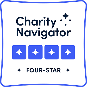 Charity Navigator Four-Star rating badge with four blue stars and sparkling star icons, indicating a top charity rating.