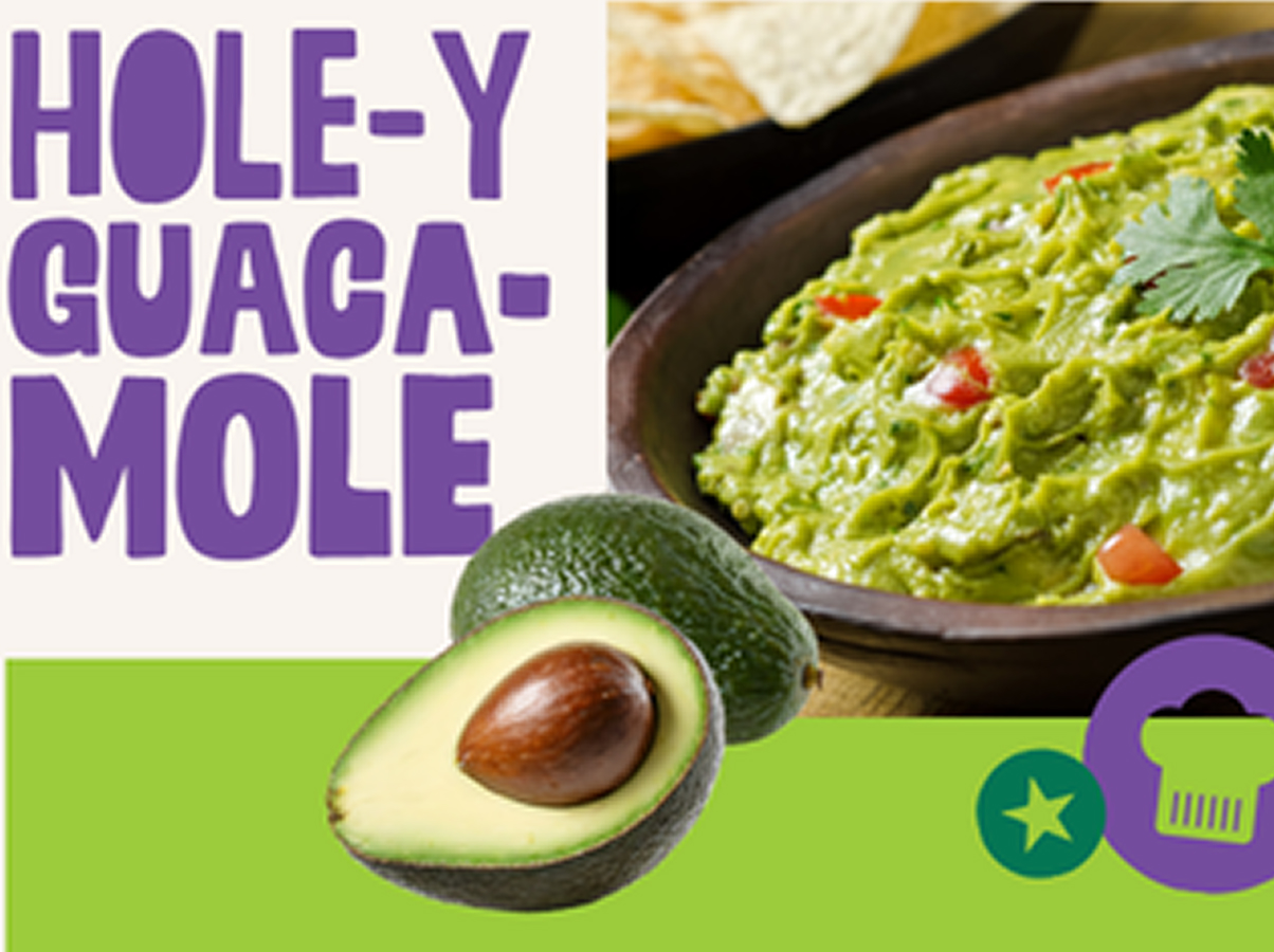 A bowl of guacamole with diced tomatoes and cilantro, a halved avocado, and tortilla chips. Large purple text reads HOLE-Y GUACAMOLE. Green icons of a star and shopping basket are in the corner.